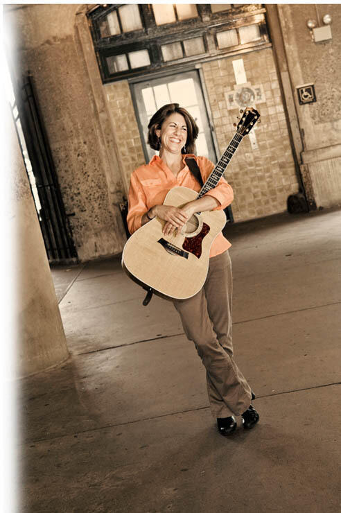 peri with guitar in empty building